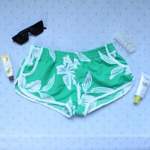 green and white lifeguard hawaiian flower shorts